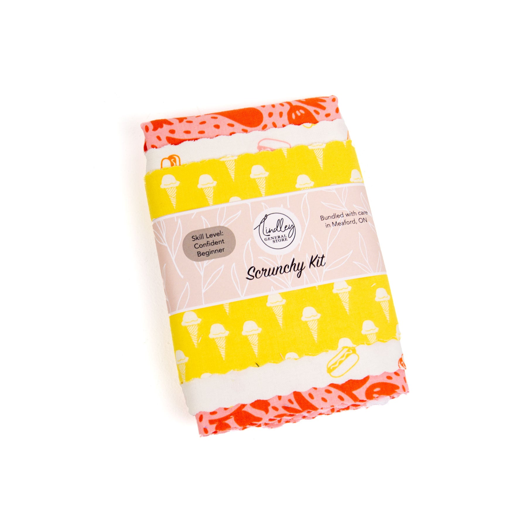 Packaged scrunchy kit with colourful design on a white background