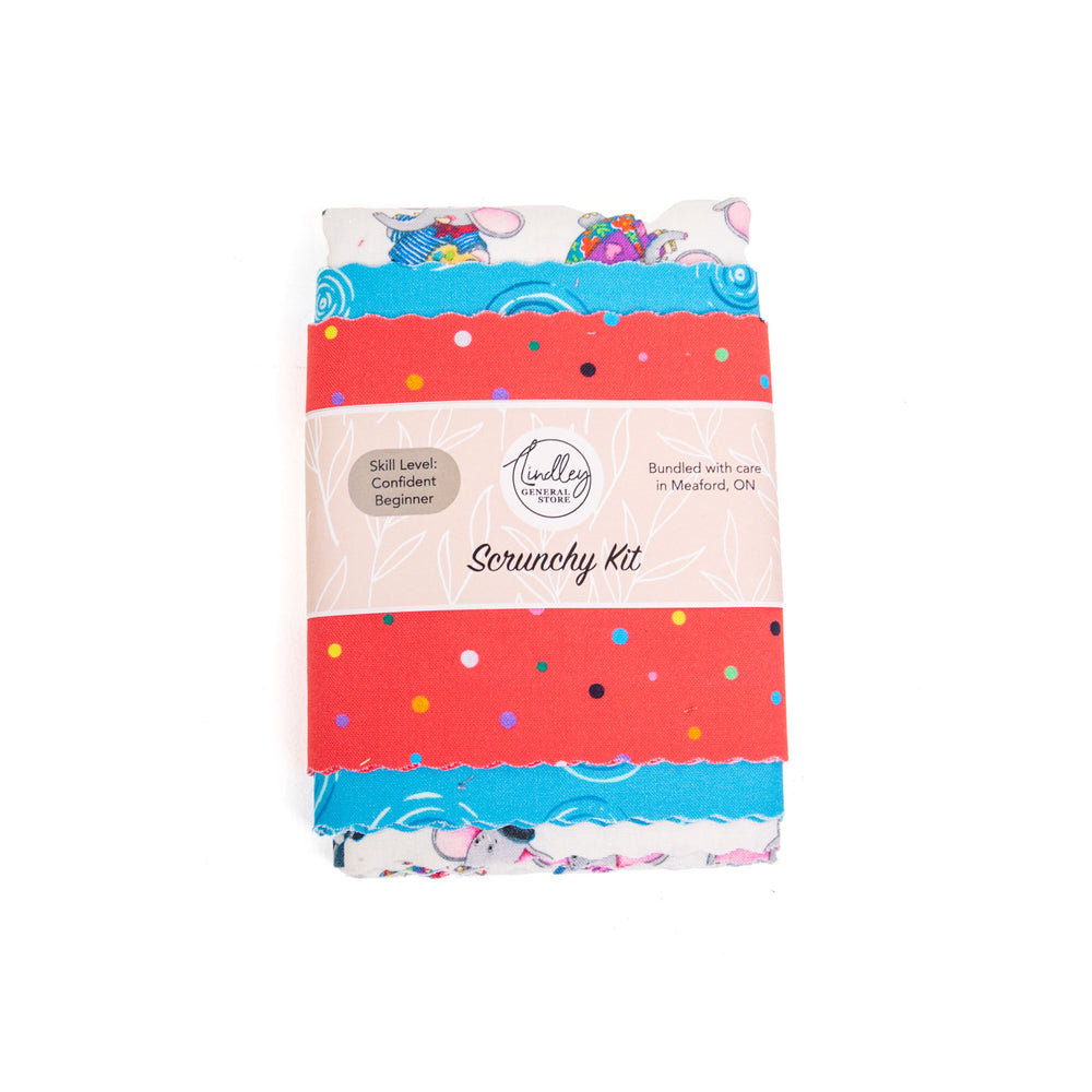 Pack of fabric to make hair scrunchies with colourful packaging on a white background